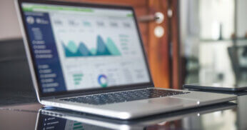 Website analytics and metrics displayed on laptop.